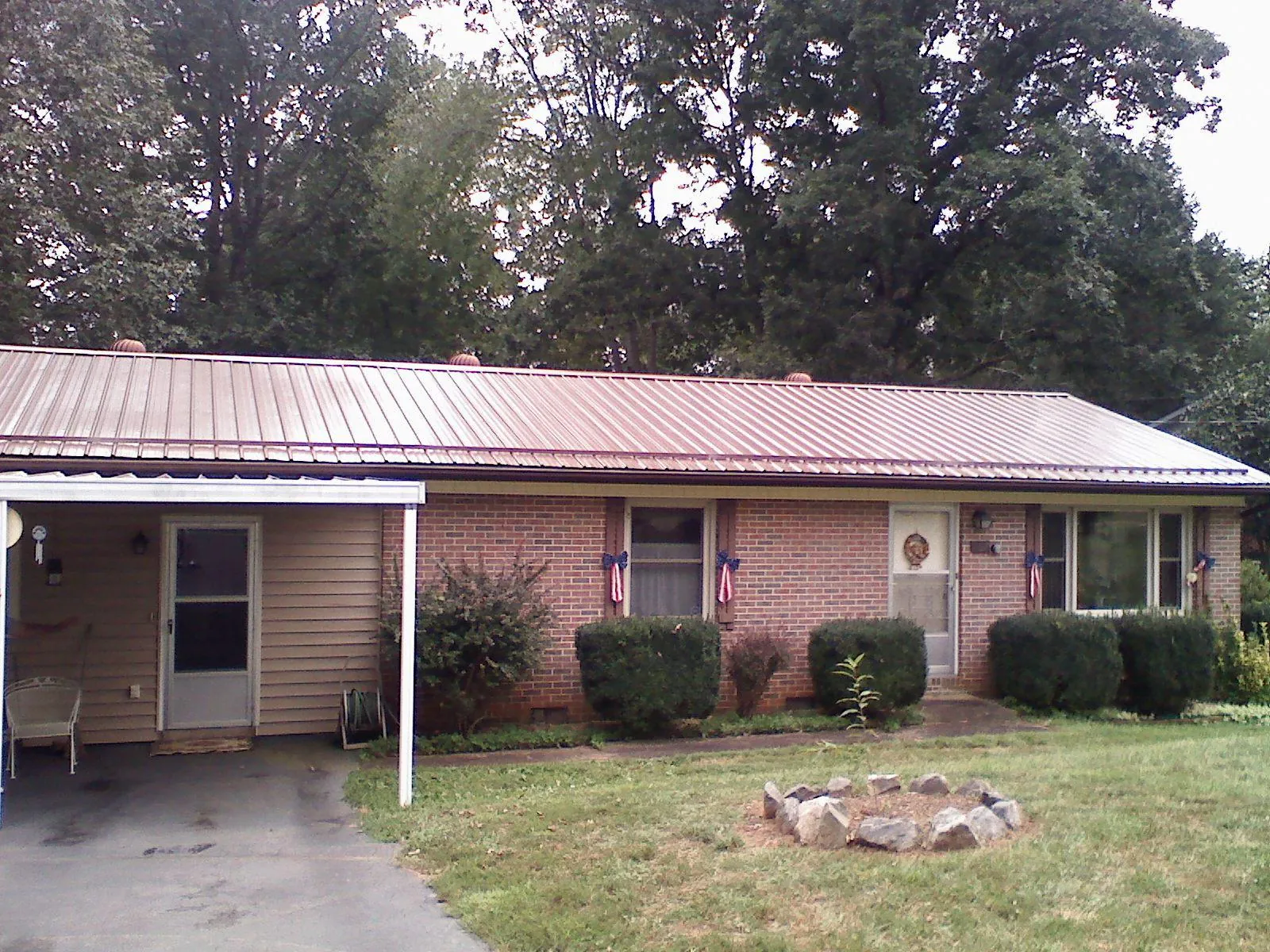 Bronze metal roof and carport on a brick ranch home — Roof Repair work by our crew in Emeryville